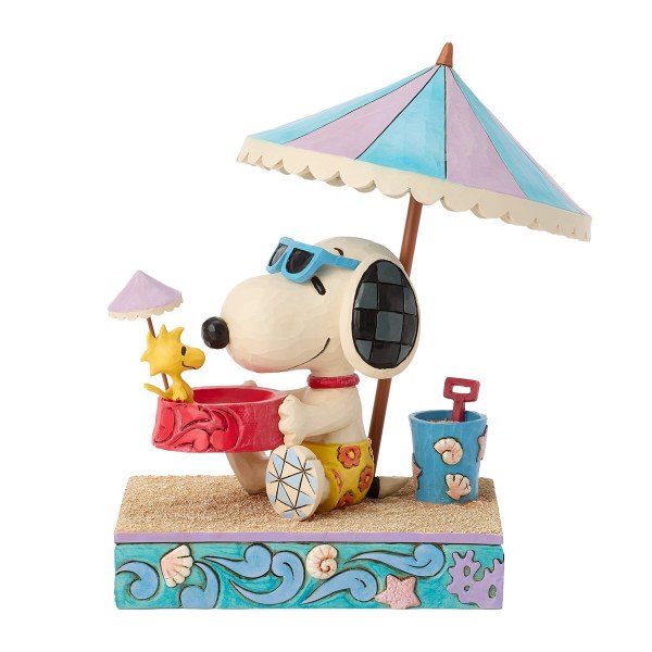Snoopy houdt Woodstock in een kom op het strand - Peanuts